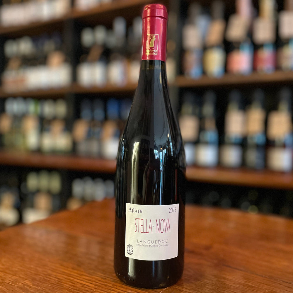 Wine Bottle standing on a wooden table with its label facing