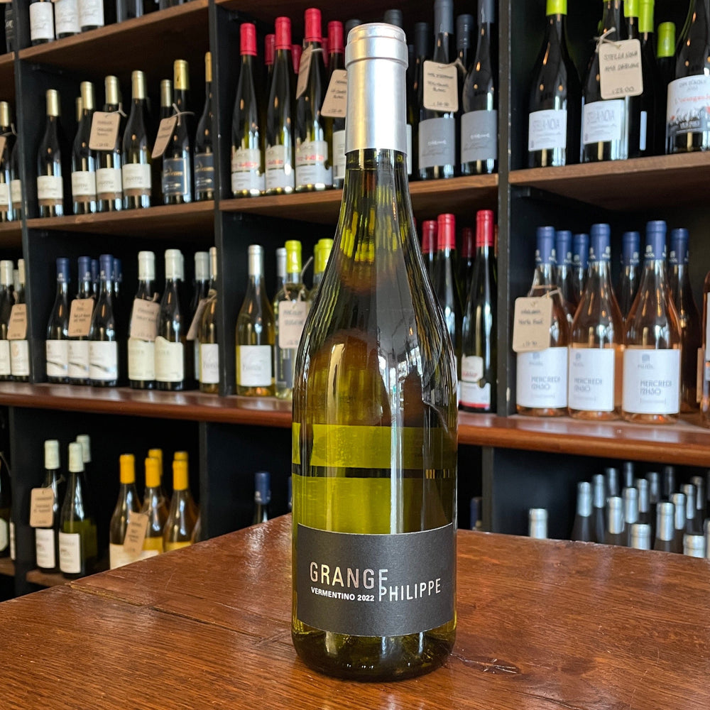 Wine Bottle standing on a wooden table with its label facing