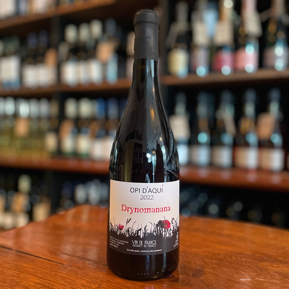 bottle of wine standing and label facing on a wooden table