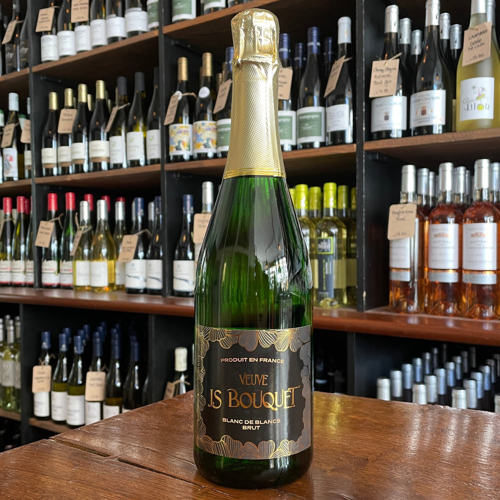 bottle of wine standing and label facing on a wooden table