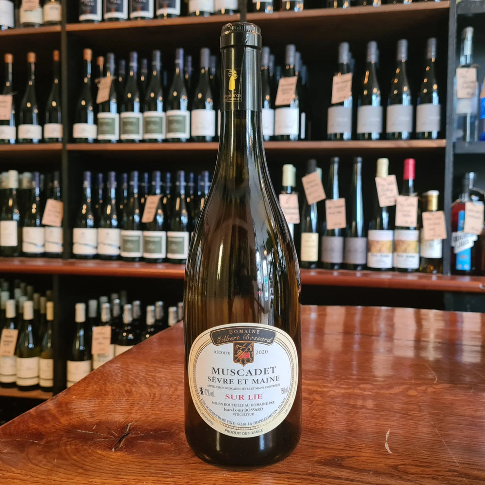 Wine Bottle standing on a wooden table with its label facing